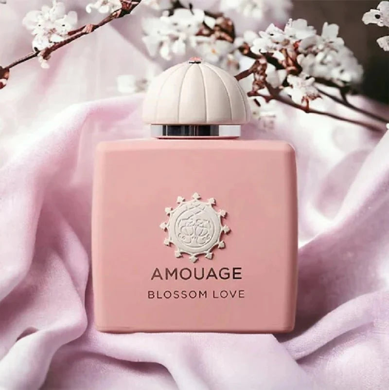 Pink amouage blossom love perfume bottle with cherry blossoms in the background