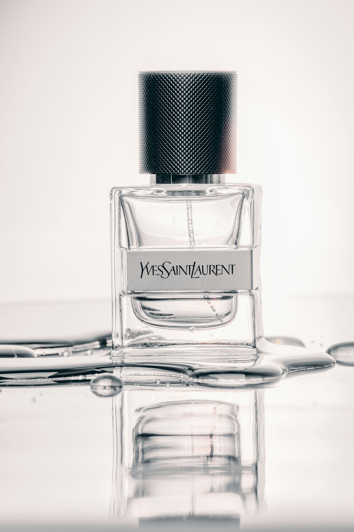 Clear glass perfume bottle on white surface