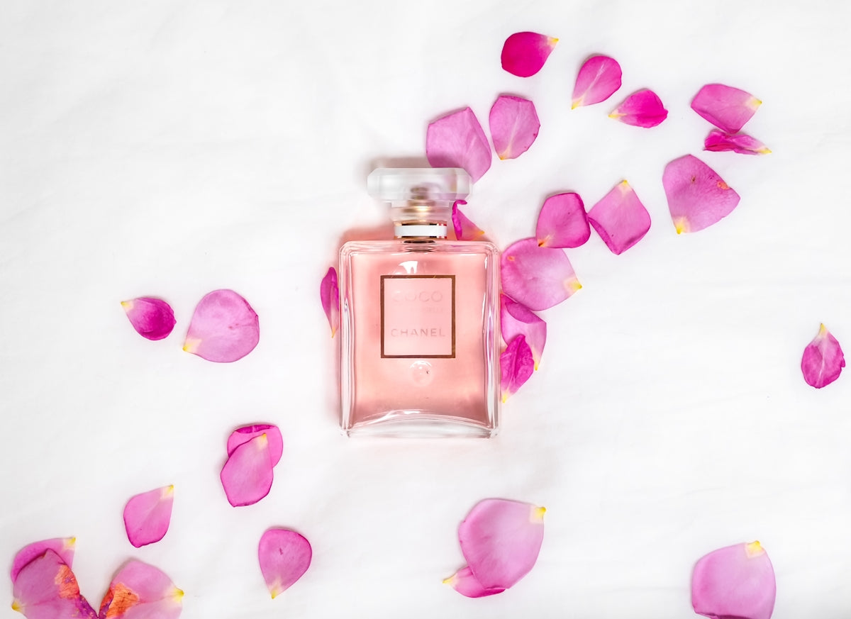 Perfume bottle with pink petals