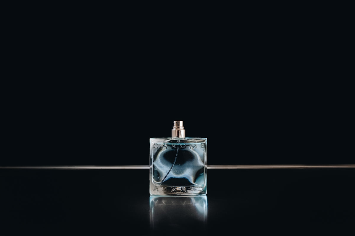 Clear glass perfume bottle with black background