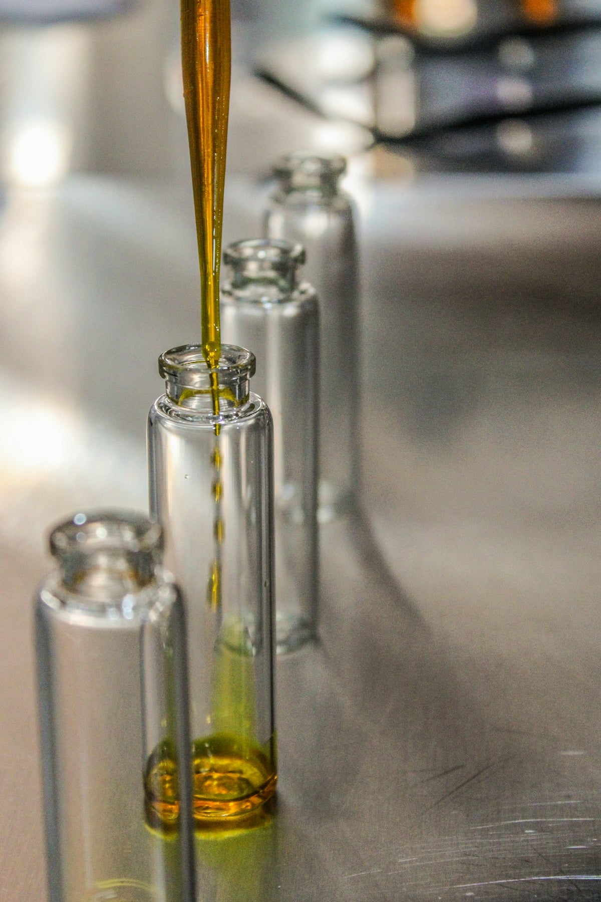 Clear glass bottle with yellow liquid