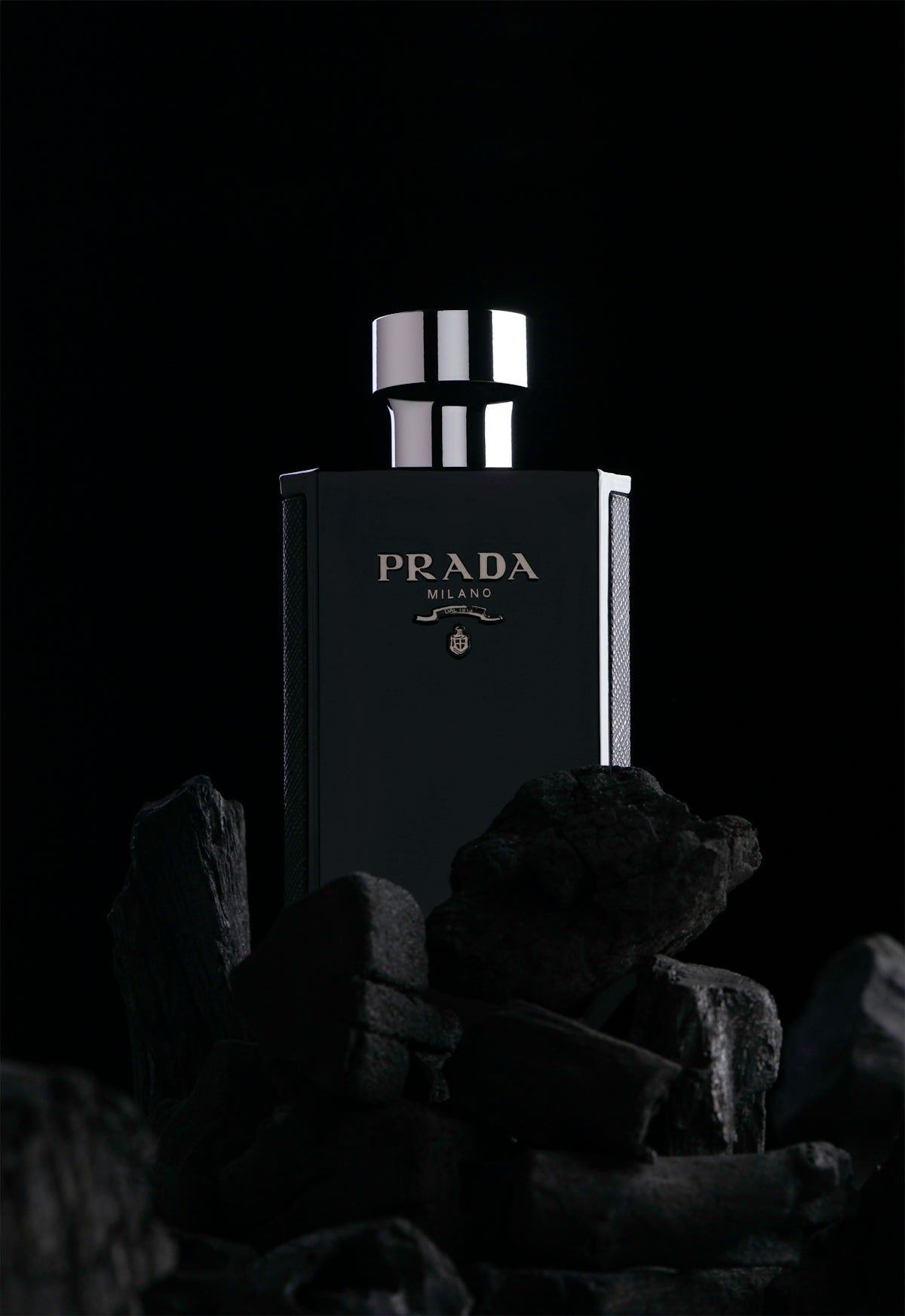 A black and white photo of a bottle of prada