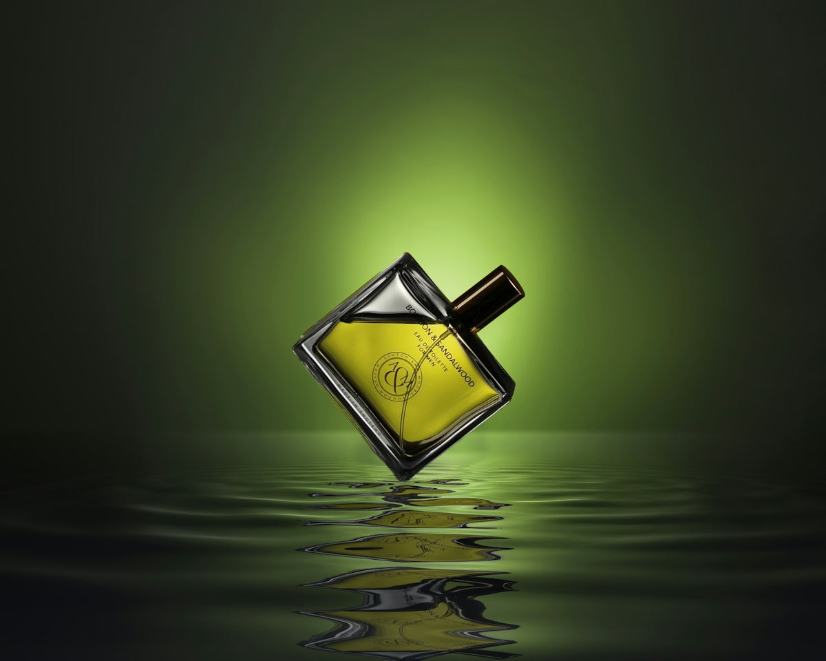 Gold colored and black perfume bottle on water