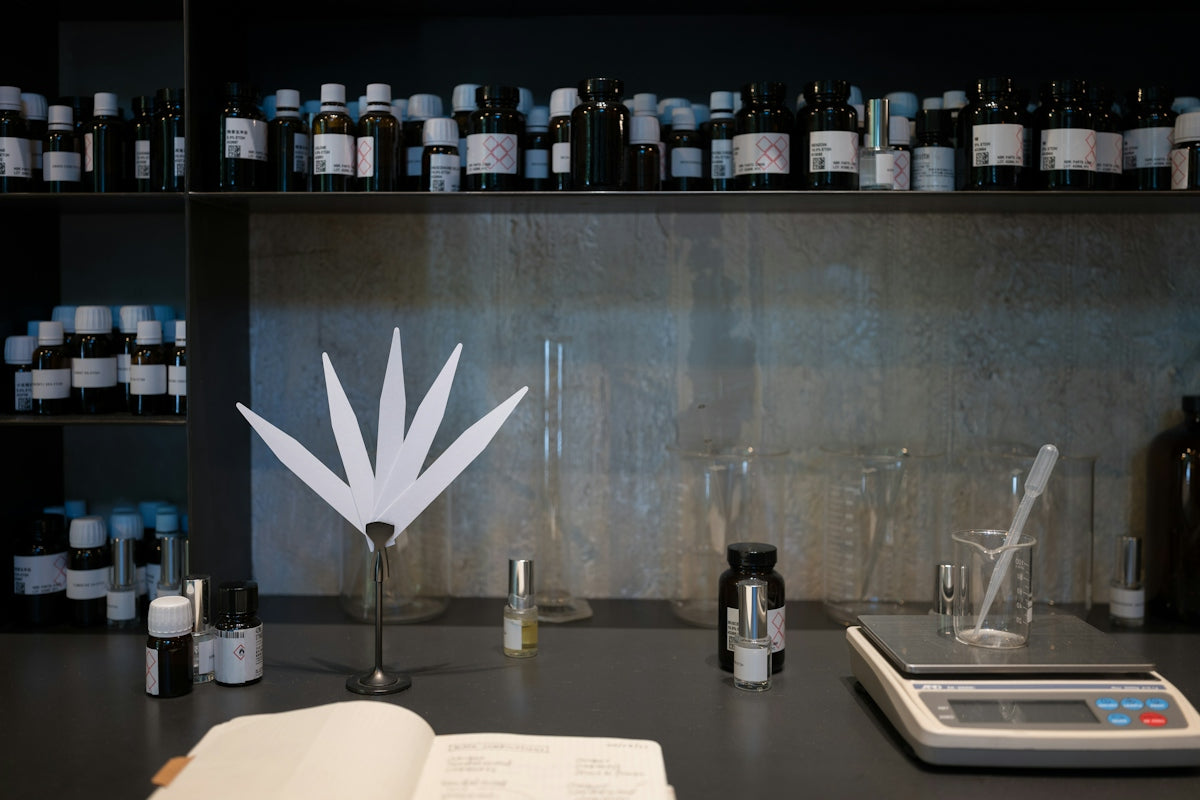 A table topped with lots of bottles and a book